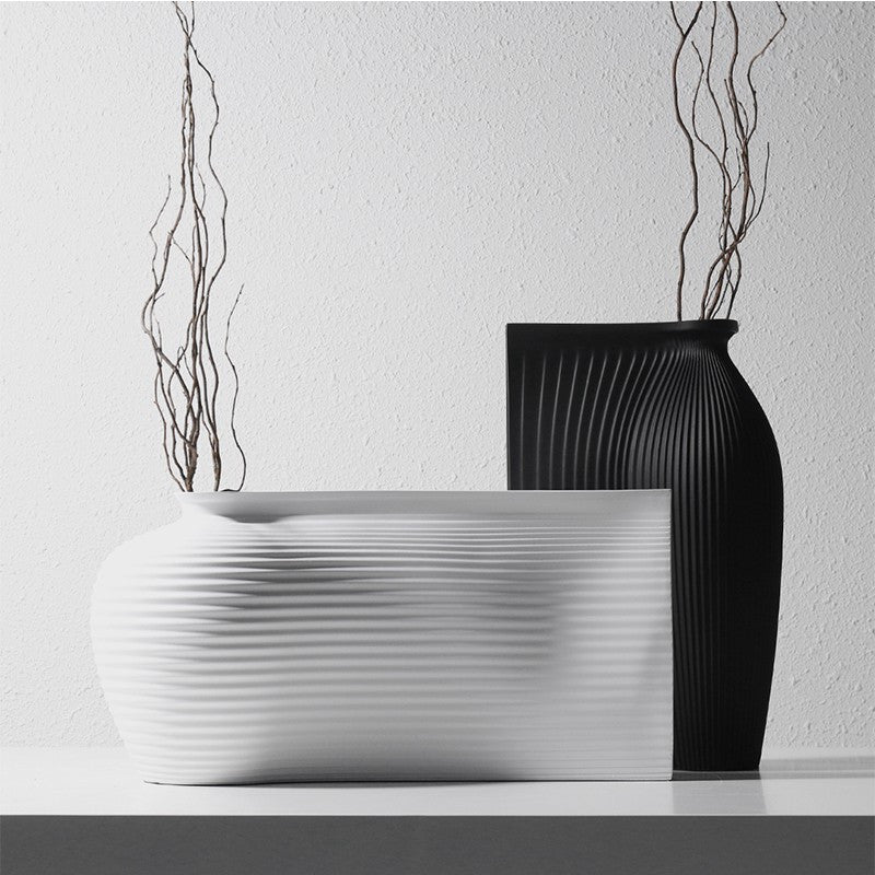 Fontaine Collection | Splayed-Leg Nordic Ceramic Vessel - styled from an alternate angle revealing dimensional depth in a Mid-Century Modern living room setting.