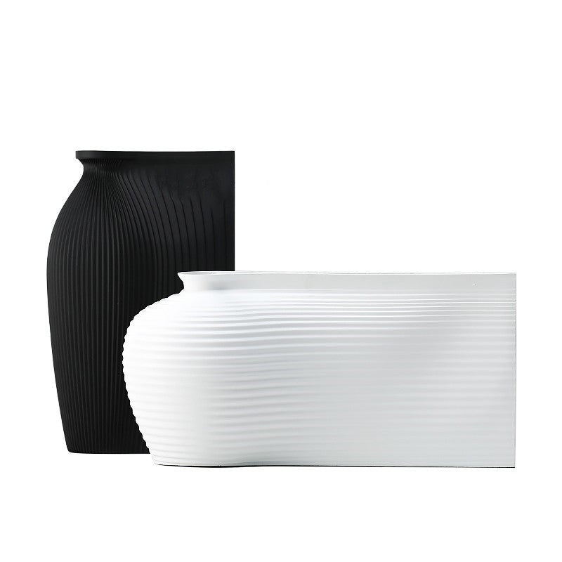 Fontaine Collection | Splayed-Leg Nordic Ceramic Vessel - revealing tonal warmth and surface patina under ambient light in a Mid-Century Modern living room setting.