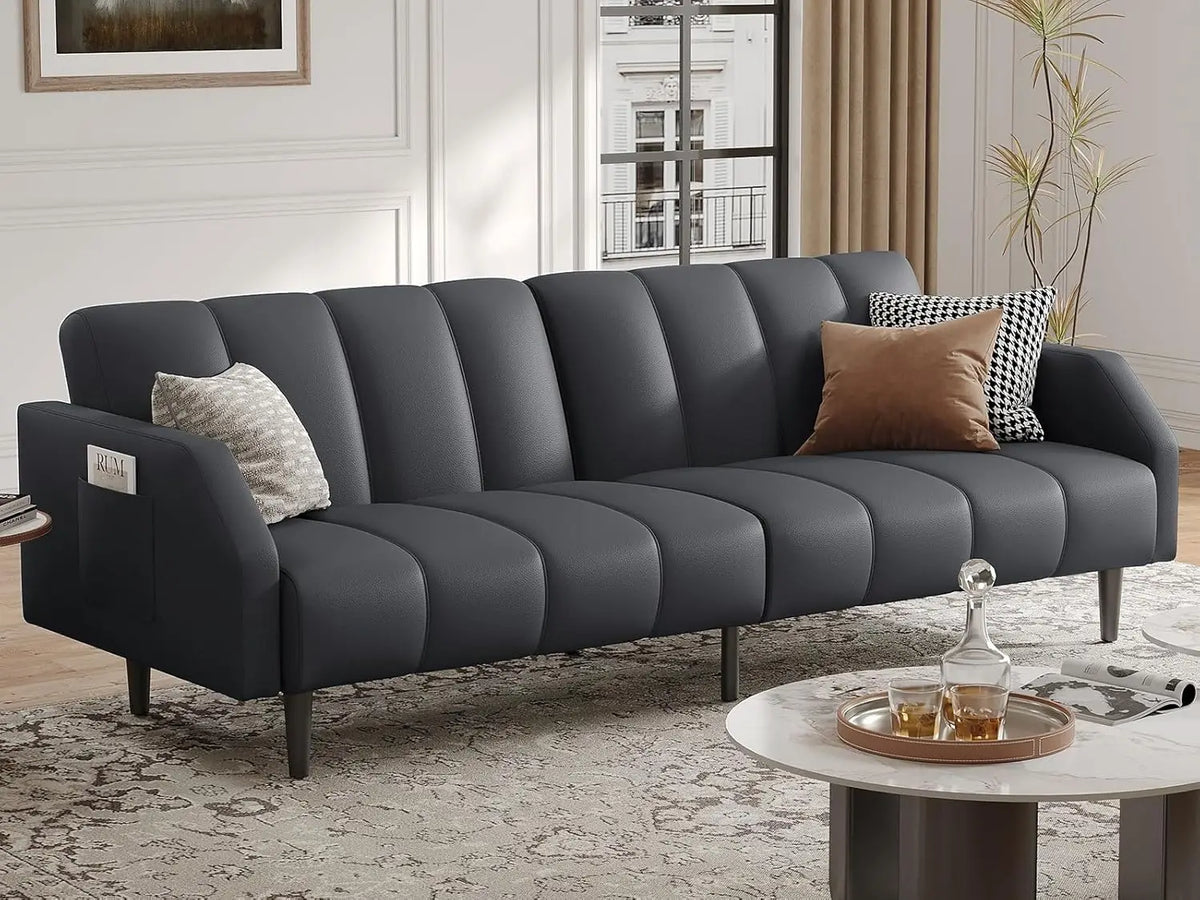 Belmont Collection | Streamlined Leather-Wrapped Convertible in Luxe Faux Leather - framed in an editorial still-life composition in a Mid-Century Modern living room setting.