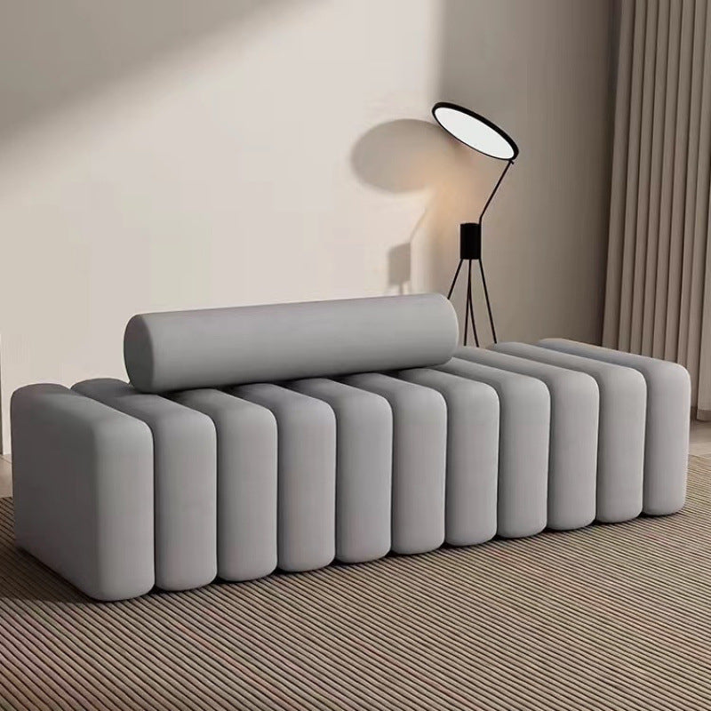 Ellington Collection | Tapered-Leg Brass-Accented Walnut Storage Bench - framed in an editorial still-life composition in a Mid-Century Modern living room setting.