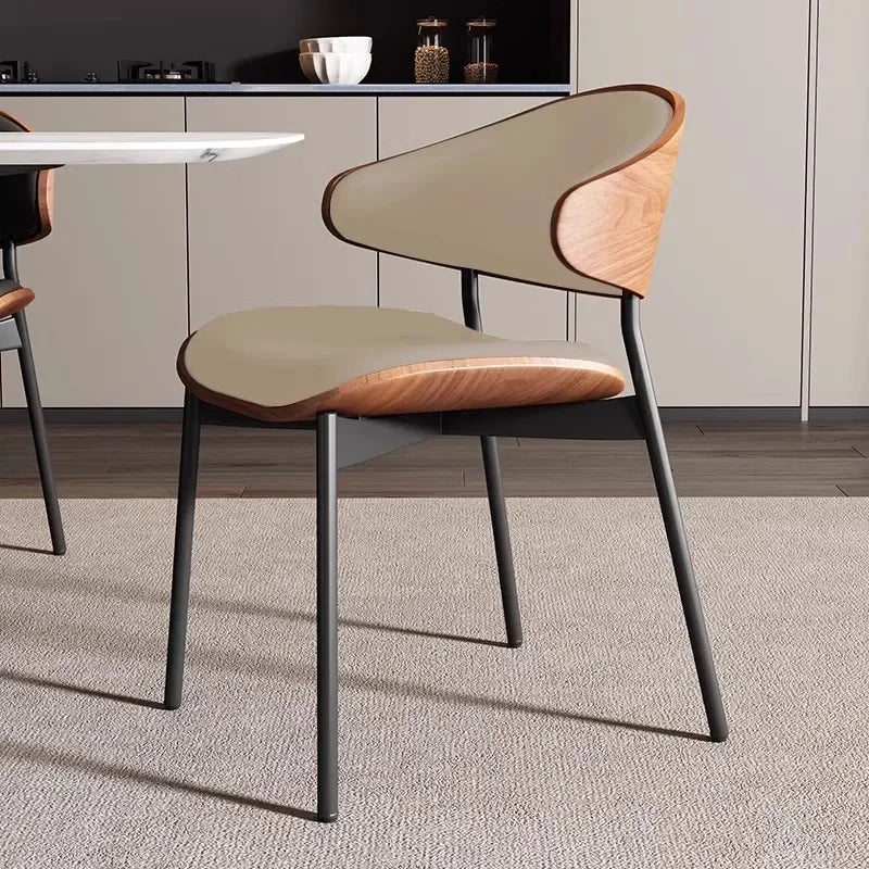 Fontaine Collection | Geometric Leather-Wrapped Cognac Leather Dining Chairs - framed in an editorial still-life composition in a Mid-Century Modern dining room setting.