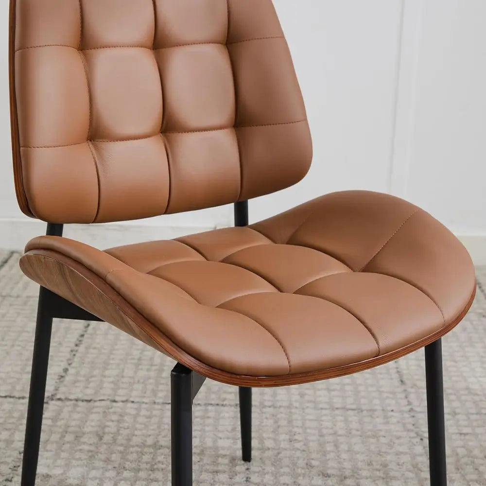 Fontaine Collection | Sculptural Chrome-Detailed Cognac Leather Dining Set - presented at scale within a designed interior in a Mid-Century Modern dining room setting.