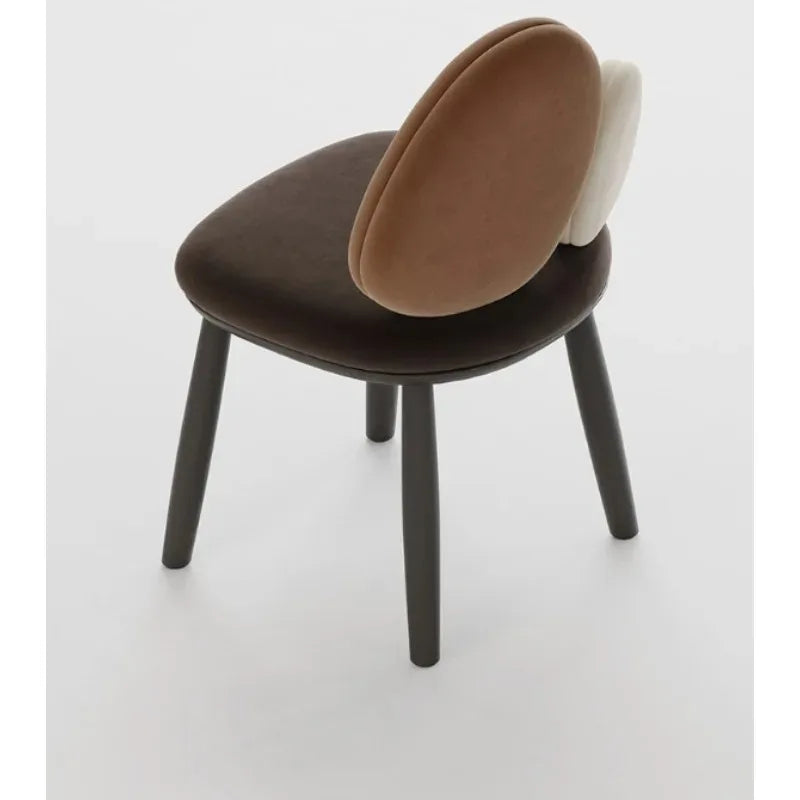 Ellington Collection | Round Atomic-Era Solid Walnut Dining Chairs - framed in an editorial still-life composition in a Mid-Century Modern dining room setting.
