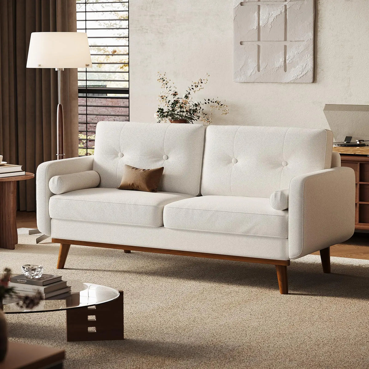 Ellington Collection | Leather-Wrapped Walnut Loveseat - framed in an editorial still-life composition in a Mid-Century Modern living room setting.